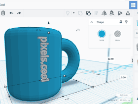 A 3D modeling software interface showing a blue mug with the text "pixels.cool" on its side.