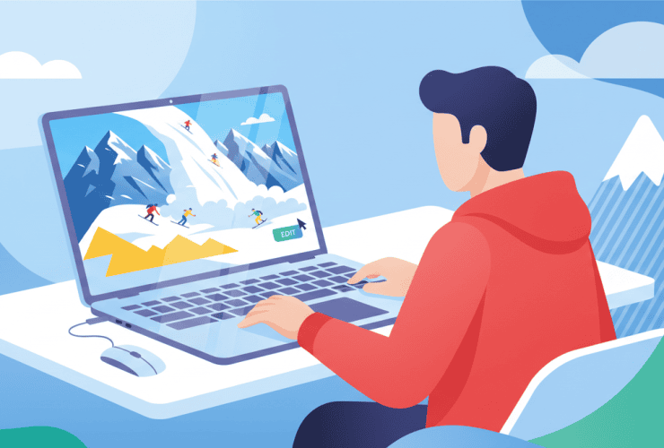 A person in a red hoodie uses a laptop showing a mountain scene with climbers; snowy peaks appear in the background.