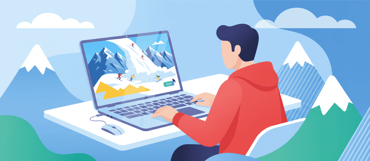 A person in a red hoodie uses a laptop showing a mountain scene with climbers; snowy peaks appear in the background.