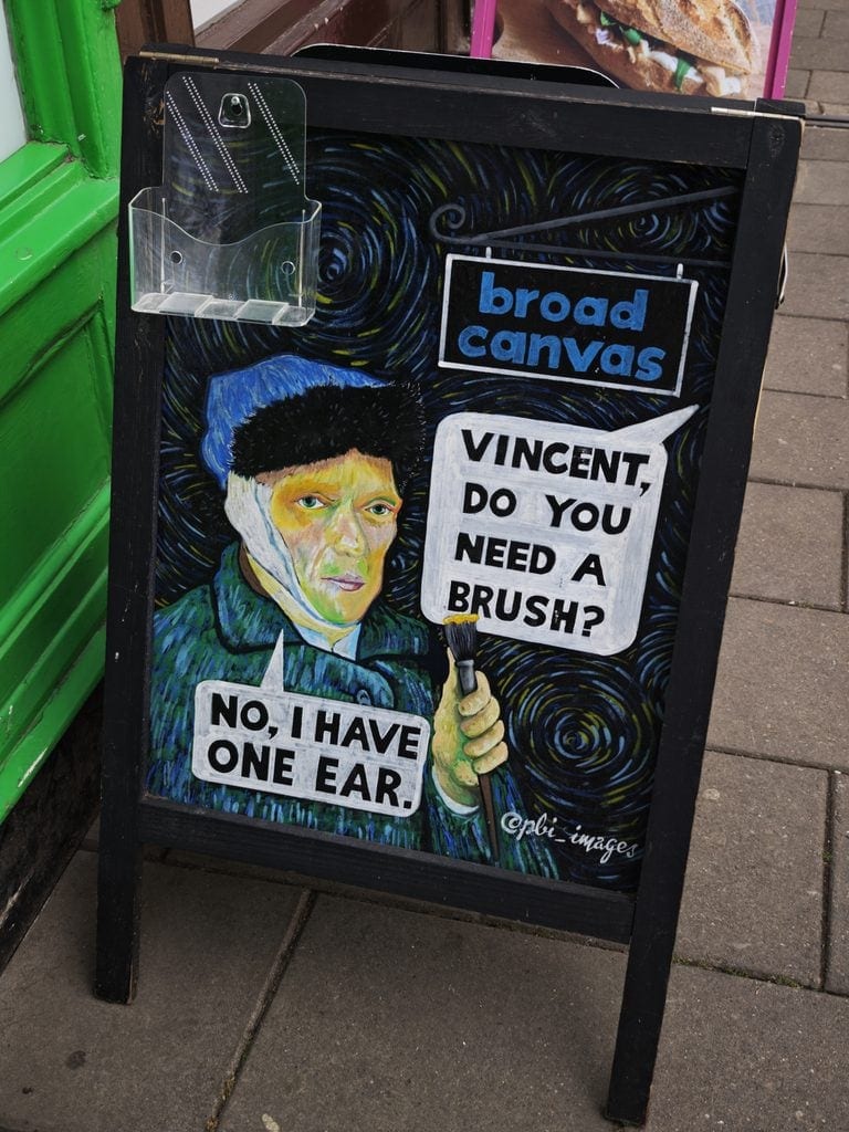 Chalkboard with a Van Gogh caricature, a bandaged ear, and text about needing a brush and having one ear.