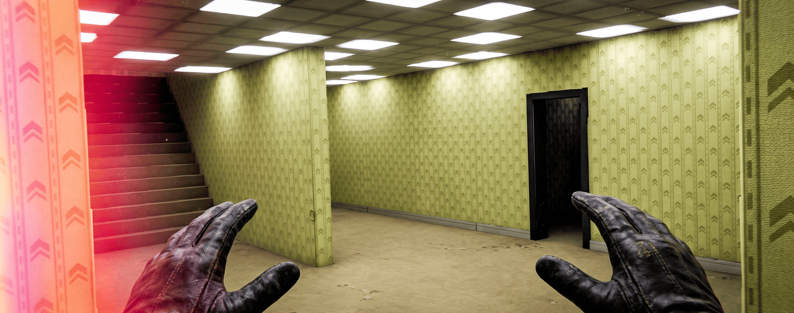First-person view of leather-gloved hands in a room with yellow patterned wallpaper, a dark doorway, and a staircase.